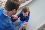 Uncle Gabe plays catcher as Wyatt enjoys his first time on a slide